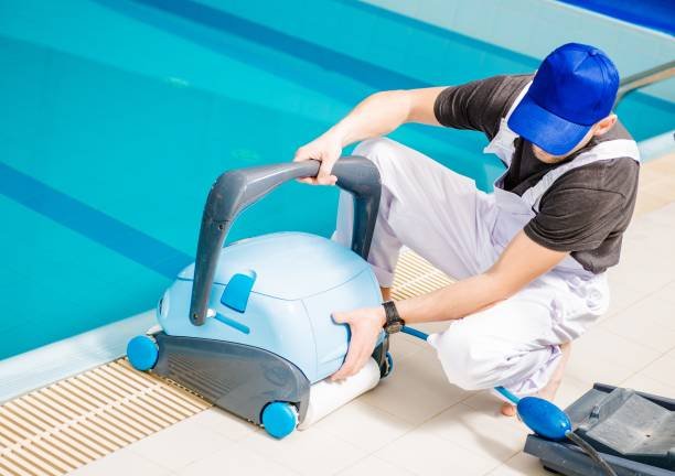 Caucasian Swimming Pools Technician with Cleaning Machine.
